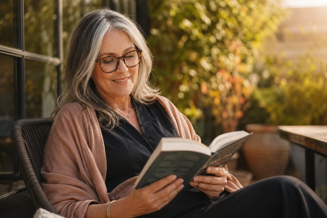 Mature woman wearing stylish glasses reading outdoors - presbyopia guide